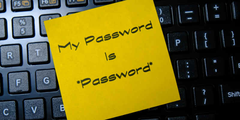 A yellow sticky note on a keyboard with the text 